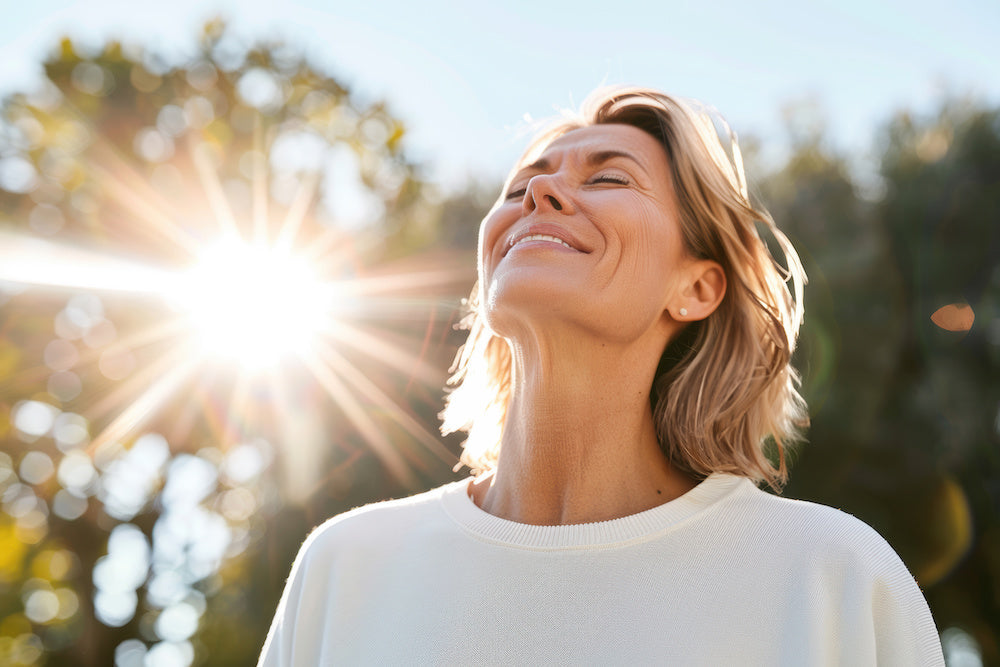 managing menopause symptoms woman with face in the sun